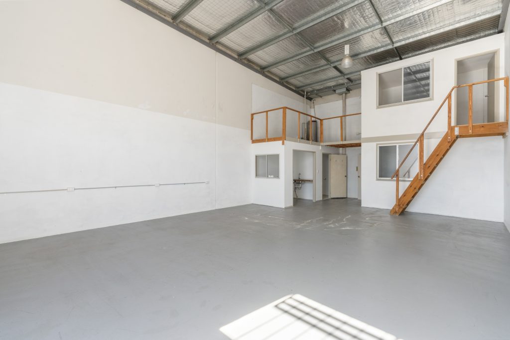 Warehouse interior at 3/3 Ramly Drive, Burleigh Heads, showing the open floor and mezzanine